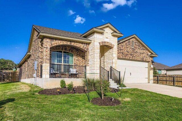 236 Cinnamon Loop, Burnet, TX 78611 - french country style house with brick siding, a garage, driveway, and stone siding