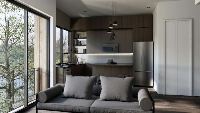 2500 Rosewood Ave Unit 103, Austin, TX 78702 - kitchen featuring freestanding refrigerator, dark countertops, modern cabinets, dark wood-style floors, and backsplash