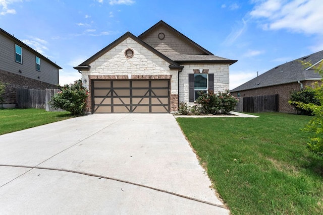 633 Weizenbock Ln, Austin, TX 78728 - view of front of home with driveway, stone siding, and a garage
