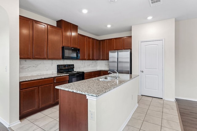 633 Weizenbock Ln, Austin, TX 78728 - kitchen featuring black appliances, light tile patterned floors, light stone countertops, backsplash, and recessed lighting