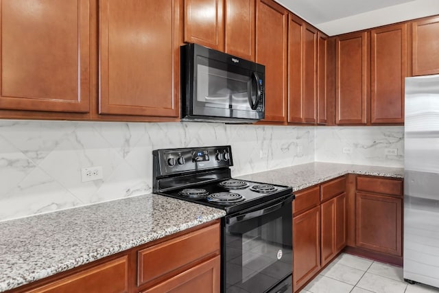 633 Weizenbock Ln, Austin, TX 78728 - kitchen with black appliances, light stone counters, tasteful backsplash, and brown cabinets
