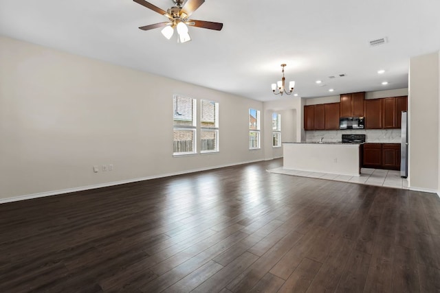 633 Weizenbock Ln, Austin, TX 78728 - unfurnished living room featuring a chandelier, wood finished floors, recessed lighting, and a ceiling fan