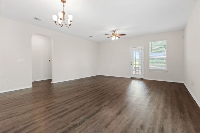633 Weizenbock Ln, Austin, TX 78728 - unfurnished room with arched walkways, a ceiling fan, dark wood-style floors, and a chandelier