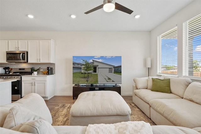 13821 Zuhause Dr, Pflugerville, TX 78660 - living area with light wood finished floors, a ceiling fan, and recessed lighting