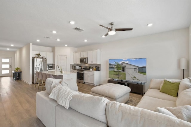 13821 Zuhause Dr, Pflugerville, TX 78660 - living area featuring ceiling fan, wood finished floors, and recessed lighting