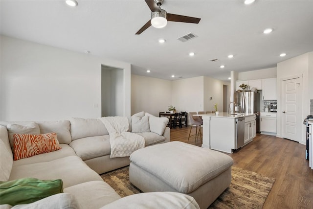 13821 Zuhause Dr, Pflugerville, TX 78660 - living room with ceiling fan, dark wood-style flooring, and recessed lighting