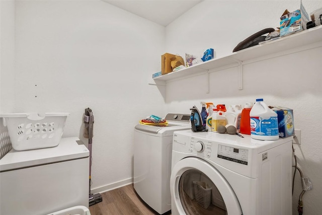 13821 Zuhause Dr, Pflugerville, TX 78660 - laundry area featuring washer and clothes dryer and wood finished floors