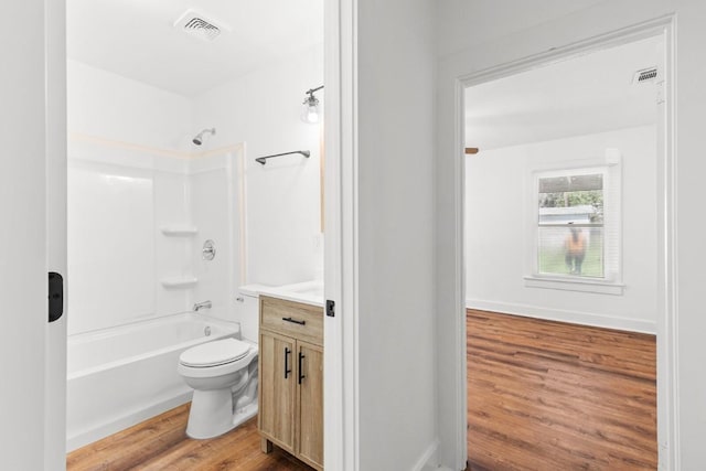 1020 S 23rd St, Temple, TX 76504 - bathroom featuring wood finished floors, vanity, and shower / washtub combination