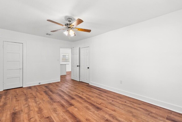 1020 S 23rd St, Temple, TX 76504 - unfurnished bedroom with wood finished floors and ceiling fan