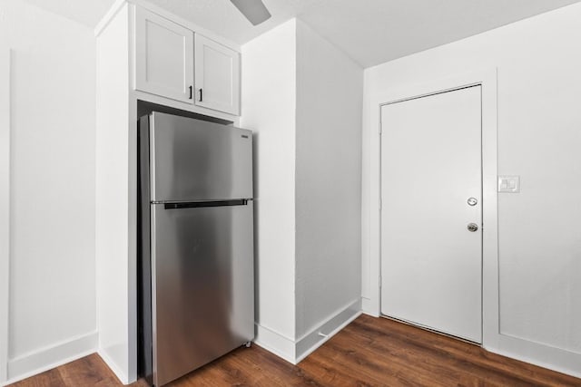 1020 S 23rd St, Temple, TX 76504 - kitchen with freestanding refrigerator, dark wood finished floors, and white cabinets