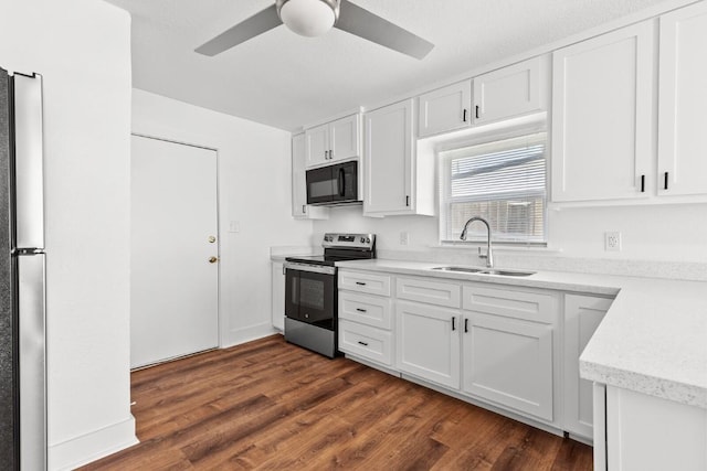 1020 S 23rd St, Temple, TX 76504 - kitchen featuring appliances with stainless steel finishes, a ceiling fan, white cabinets, and dark wood-type flooring