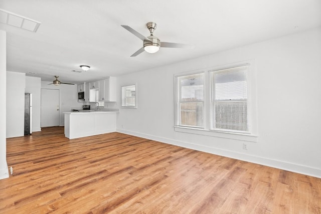 1020 S 23rd St, Temple, TX 76504 - unfurnished living room featuring ceiling fan and light wood-style flooring