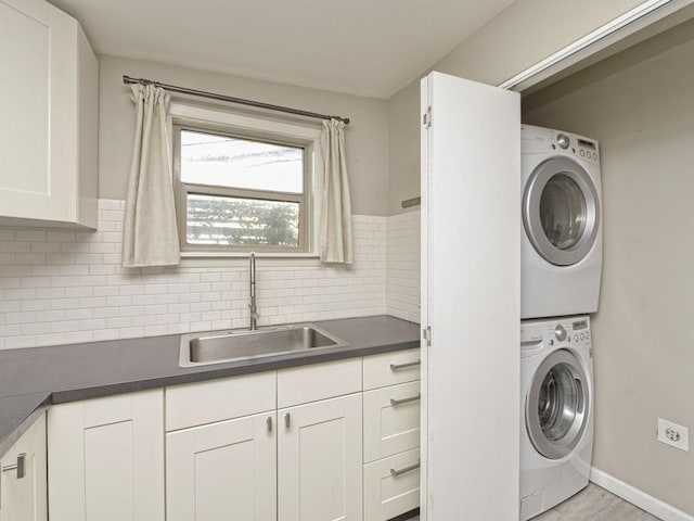 4408 Mount Vernon Dr, Austin, TX 78745 - laundry room with stacked washer and clothes dryer and baseboards