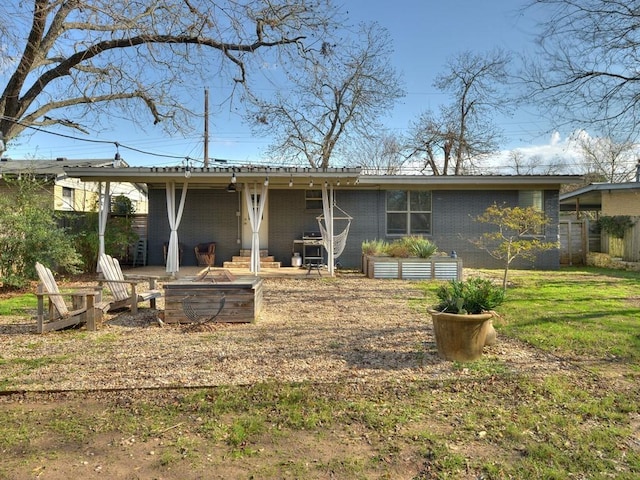 4408 Mount Vernon Dr, Austin, TX 78745 - back of property with an outdoor fire pit and brick siding