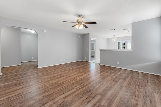 184 Atlantis, Kyle, TX 78640 - unfurnished living room with ceiling fan, wood finished floors, and arched walkways