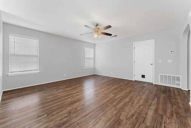 184 Atlantis, Kyle, TX 78640 - unfurnished room with a ceiling fan, arched walkways, and wood finished floors