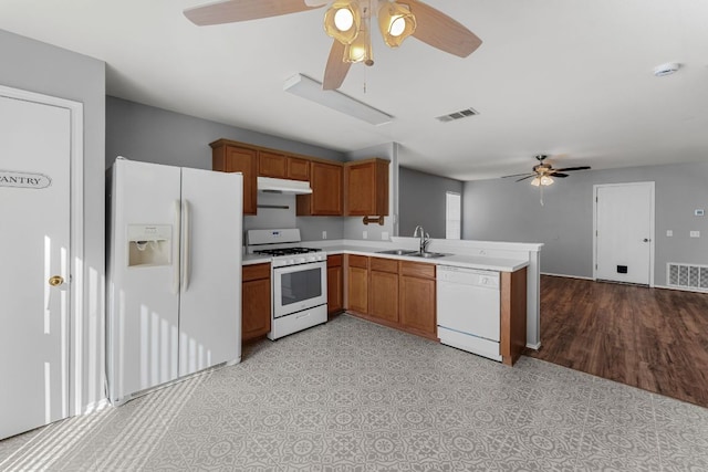 184 Atlantis, Kyle, TX 78640 - kitchen with ceiling fan, white appliances, a peninsula, light countertops, and brown cabinets