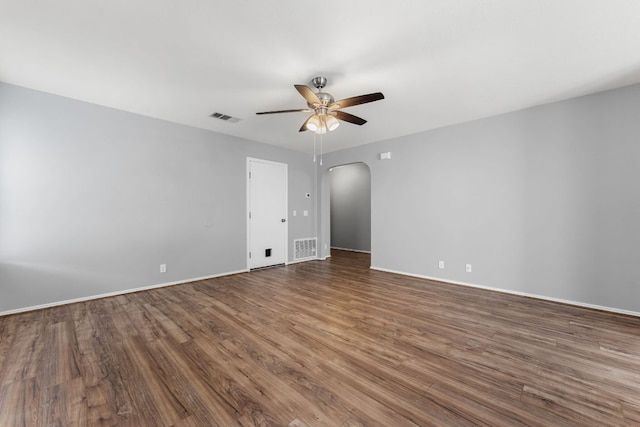 184 Atlantis, Kyle, TX 78640 - empty room featuring ceiling fan, arched walkways, and wood finished floors