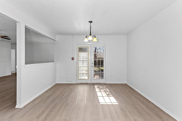 500 Honeysuckle Dr, Cedar Park, TX 78613 - unfurnished dining area with wood finished floors, a textured ceiling, ceiling fan, and a chandelier