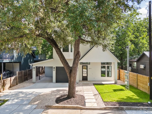 2917 Lyons Rd Unit 1, Austin, TX 78702 - view of front facade with concrete driveway, an attached garage, and stucco siding