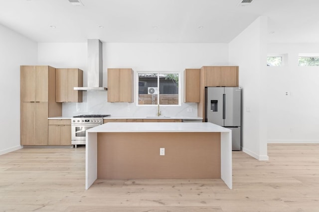 2917 Lyons Rd Unit 1, Austin, TX 78702 - kitchen with a kitchen island, light wood-style flooring, stainless steel appliances, and light countertops