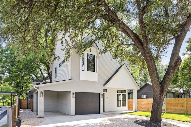 2917 Lyons Rd Unit 1, Austin, TX 78702 - view of front of house featuring an attached garage and driveway