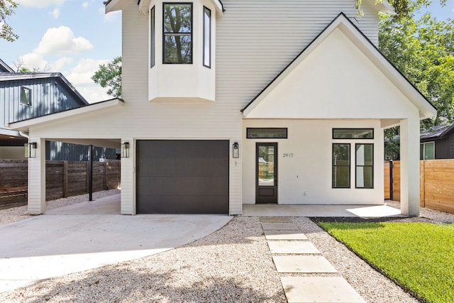 2917 Lyons Rd Unit 1, Austin, TX 78702 - view of front of home featuring driveway, an attached garage, and stucco siding