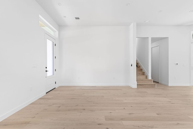 2917 Lyons Rd Unit 1, Austin, TX 78702 - empty room featuring stairway and light wood-type flooring