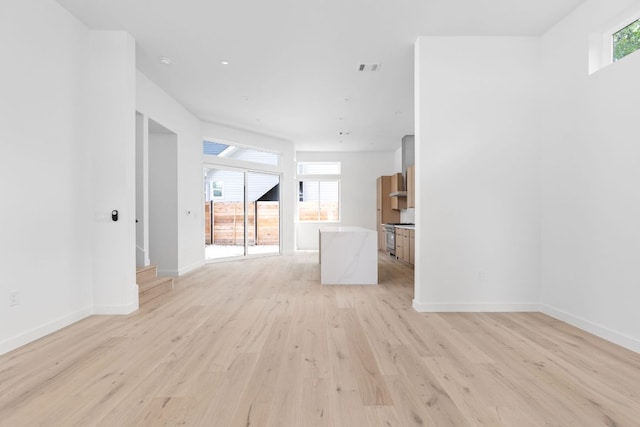 2917 Lyons Rd Unit 1, Austin, TX 78702 - unfurnished living room with light wood-style flooring and baseboards