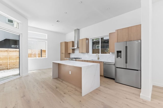 2917 Lyons Rd Unit 1, Austin, TX 78702 - kitchen with a center island, appliances with stainless steel finishes, light countertops, and light wood finished floors