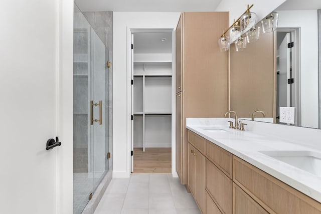 2917 Lyons Rd Unit 1, Austin, TX 78702 - full bathroom featuring a shower stall, double vanity, a walk in closet, and tile patterned flooring