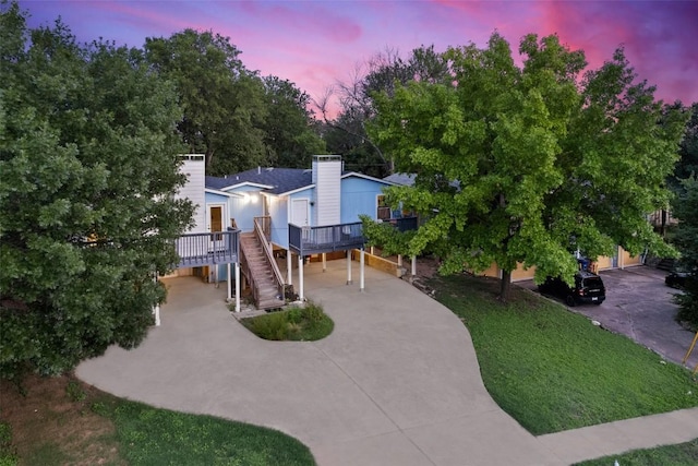2503 Parker Ln Unit A & B, Austin, TX 78741 - view of front of property featuring concrete driveway, stairs, a chimney, and a carport