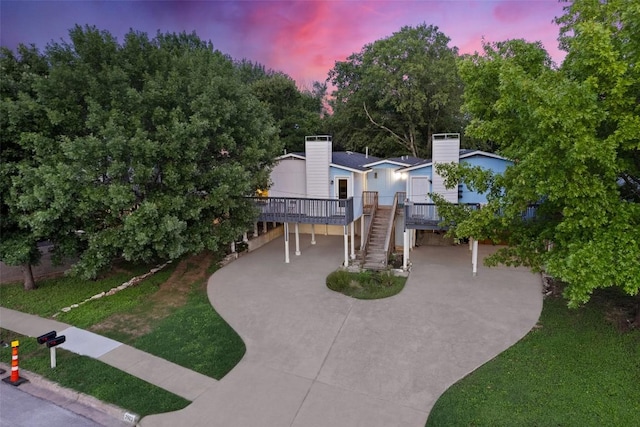 2503 Parker Ln Unit A & B, Austin, TX 78741 - view of front of property with concrete driveway, stairs, a chimney, a carport, and a wooden deck