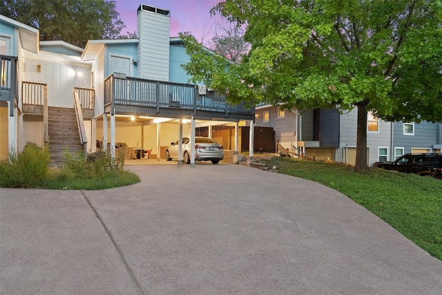 2503 Parker Ln Unit A & B, Austin, TX 78741 - view of front facade featuring a chimney, concrete driveway, stairway, a lawn, and a wooden deck
