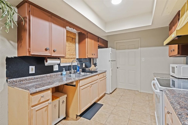 2503 Parker Ln Unit A & B, Austin, TX 78741 - kitchen featuring white appliances, extractor fan, light tile patterned flooring, decorative backsplash, and a tray ceiling
