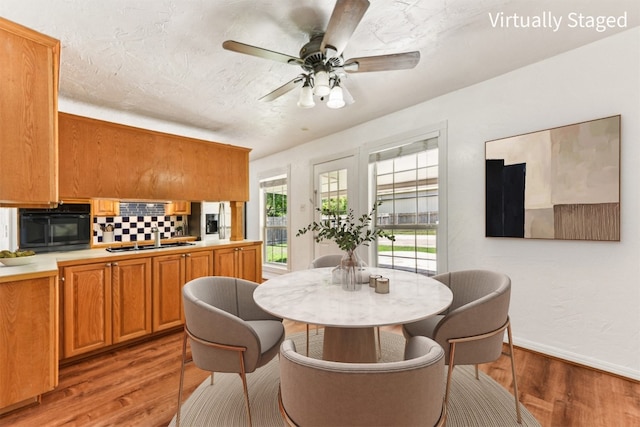 8511 Slant Oak Dr, Austin, TX 78729 - dining room with light wood-type flooring and ceiling fan