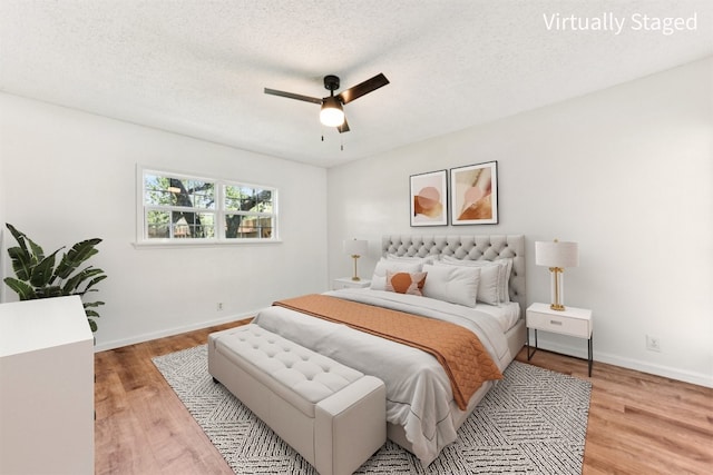 8511 Slant Oak Dr, Austin, TX 78729 - bedroom featuring light wood finished floors, ceiling fan, and a textured ceiling