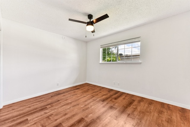 8511 Slant Oak Dr, Austin, TX 78729 - unfurnished room with ceiling fan, wood finished floors, and a textured ceiling