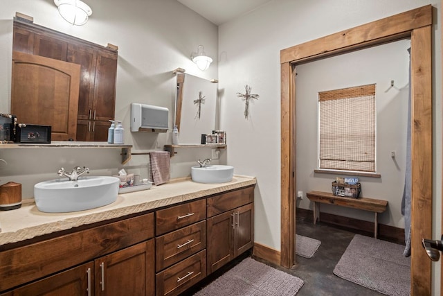201 N Oak Vista Dr, Burnet, TX 78611 - full bathroom with double vanity and concrete floors