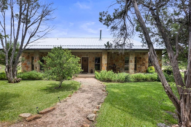 201 N Oak Vista Dr, Burnet, TX 78611 - view of front of home featuring stone siding, a front yard, a metal roof, and covered porch