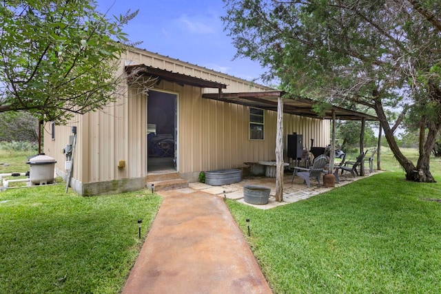 201 N Oak Vista Dr, Burnet, TX 78611 - back of house with a yard, entry steps, a patio, and board and batten siding