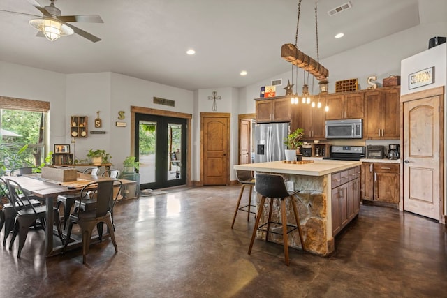 201 N Oak Vista Dr, Burnet, TX 78611 - kitchen with finished concrete flooring, plenty of natural light, a center island, light countertops, and recessed lighting