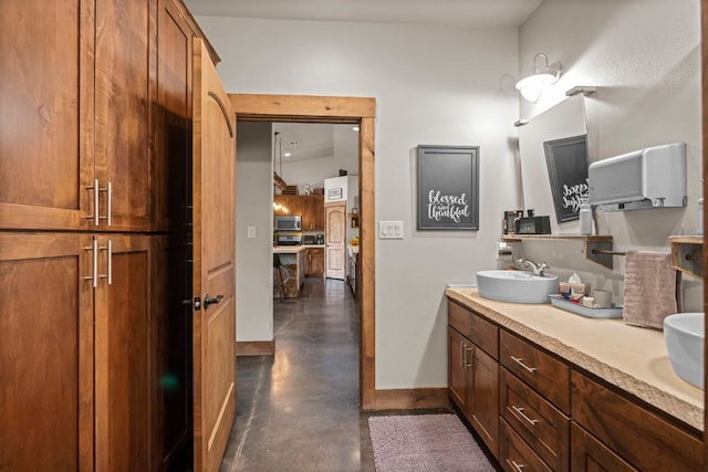 201 N Oak Vista Dr, Burnet, TX 78611 - full bathroom featuring finished concrete flooring and double vanity