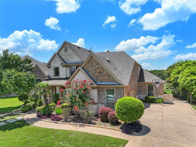 15208 Sunningdale St, Austin, TX 78717 - view of front facade featuring brick siding, a shingled roof, a front yard, and a standing seam roof