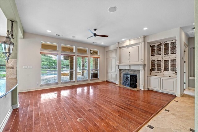 15208 Sunningdale St, Austin, TX 78717 - unfurnished living room featuring ceiling fan, a premium fireplace, recessed lighting, and light wood finished floors