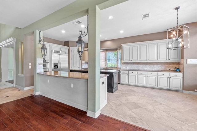 15208 Sunningdale St, Austin, TX 78717 - kitchen with white cabinets, tasteful backsplash, stainless steel built in fridge, and light stone counters