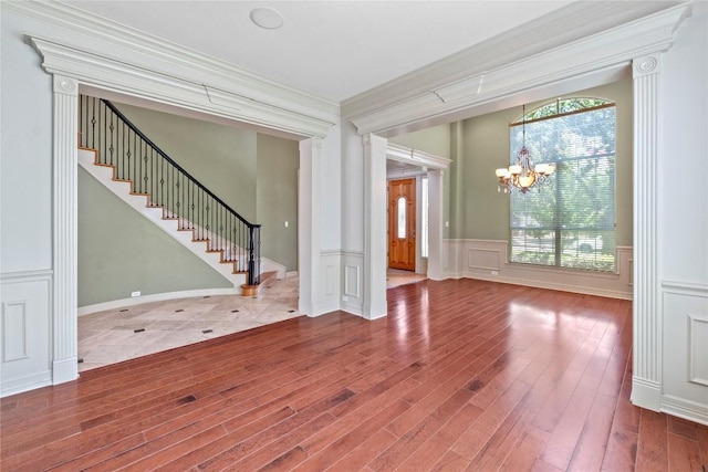 15208 Sunningdale St, Austin, TX 78717 - unfurnished living room featuring a chandelier, wood finished floors, plenty of natural light, stairway, and a decorative wall