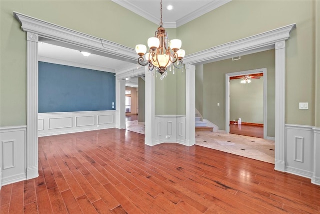 15208 Sunningdale St, Austin, TX 78717 - unfurnished dining area with crown molding, wood finished floors, a chandelier, a wainscoted wall, and stairway