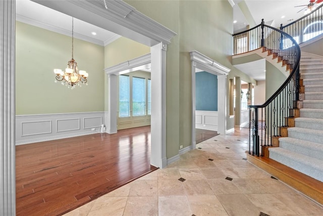 15208 Sunningdale St, Austin, TX 78717 - foyer entrance featuring a towering ceiling, a decorative wall, a chandelier, crown molding, and stairs