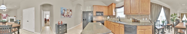 11017 Casitas Dr, Austin, TX 78717 - kitchen with black appliances, decorative backsplash, light brown cabinets, and hanging light fixtures